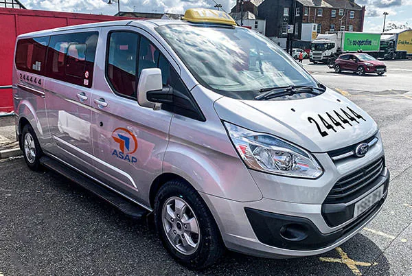 asap's 8 seat silver ford transit taxi minibus outside the red funnel terminal in east cowes